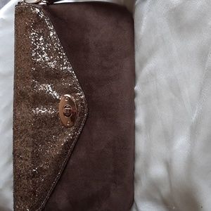 Suede like clutch purse.Detachable wrist strap.  Gold coloured sparkly t…
